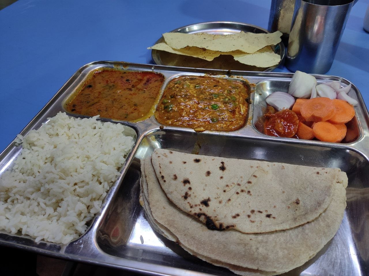 Real Indian thali with rice, roti, dal, vegetable curry, and salad